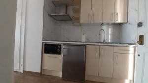 a small kitchen with a sink and a dishwasher at Port Royale MONTANA in Arona