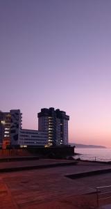 a group of tall buildings in front of the ocean at Beautiful beach in Santa Cruz de Tenerife