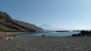 a group of people on a beach near the water at Beautiful beach in Santa Cruz de Tenerife