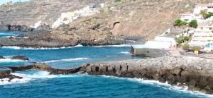 a view of a beach with rocks in the water at Beautiful beach in Santa Cruz de Tenerife