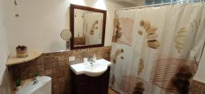 a bathroom with a sink and a shower curtain at Beautiful beach in Santa Cruz de Tenerife