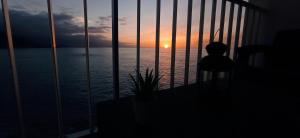 a room with a view of the ocean at sunset at Beautiful beach in Santa Cruz de Tenerife