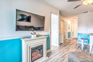 a living room with a fireplace and a tv on the wall at Surfside Beach Escape with Pool - Walk to Ocean! in Myrtle Beach