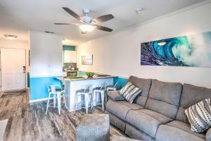 a living room with a couch and a kitchen at Surfside Beach Escape with Pool - Walk to Ocean! in Myrtle Beach