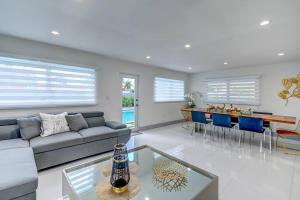 a living room with a couch and a table at Cozy paradise, with heated pool, near Airport in Miami L16 in Miami