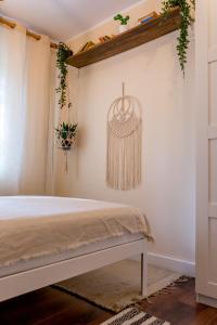 a bedroom with a bed and a hanging plant at Little Boho-Chic in Constanţa