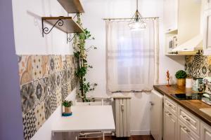 a kitchen with white cabinets and a white counter top at Little Boho-Chic in Constanţa