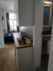 a kitchen with a sink and a counter top at Great Stay Fanqueiros 1 in Lisbon