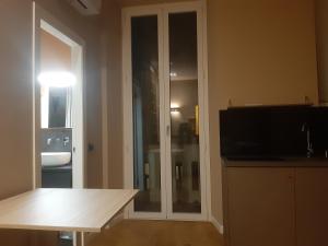 米蘭的住宿－Catenica，客厅设有滑动玻璃门和电视