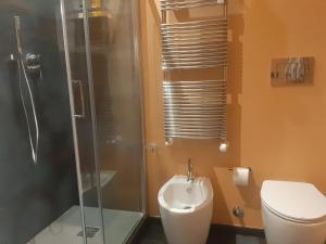 a bathroom with a shower and a toilet and a sink at Catenica in Milan