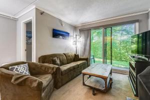 a living room with a couch and a table at Whiffletree C2 in Killington
