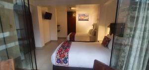 Quilla House Ecologico في ماتشو بيتشو: غرفة فندق بسرير وغرفة نوم مع نافذة