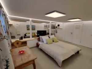 a bedroom with a large bed and a table at Appartements Berger Kitzbühel in Kitzbühel