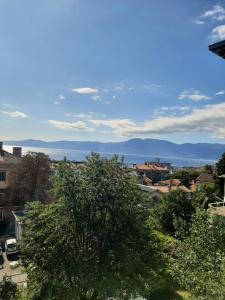 a view of the city and the ocean in the distance at Amarena Apartment in Rijeka