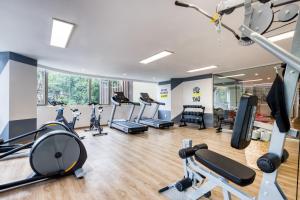 a gym with treadmills and cardio equipment in a building at ULIV Luxe Apartments Polanco in Mexico City