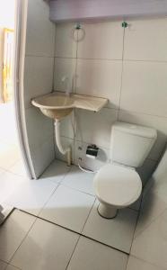 a bathroom with a toilet and a sink at Aconchego em Parnaíba JW. 2 in Parnaíba