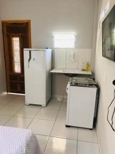 a kitchen with two refrigerators in a room at Aconchego em Parnaíba JW. 2 in Parnaíba