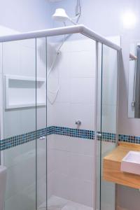 a glass shower in a bathroom with a sink at HOSTEL CUARTO in São Paulo