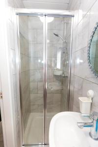 a bathroom with a shower with a sink and a toilet at Comfortable stay in Shirley, Solihull - Room 3 in Olton +7 photos