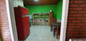 a kitchen with a red refrigerator and a table at Hospedaje Jose Gorgues in Puerto Iguazú +54 photos