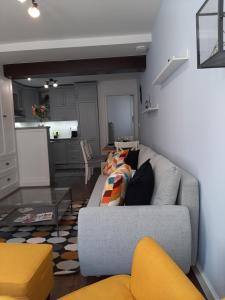 a living room with a couch and a table at NewOne Apartman in Sopron
