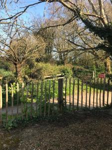 a wooden fence in front of a park at Sycamores Barn - Detached, Private, Secluded Country Retreat in Brighstone