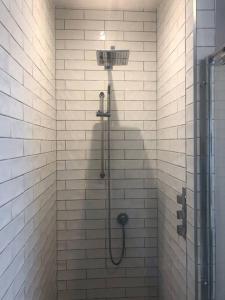 a bathroom with a shower with a shower head at HAYFIELD COTTAGE spacious detached luxury home in Copmanthorpe