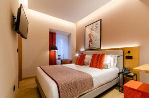 Säng eller sängar i ett rum på Rossio Plaza Hotel