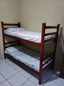 a pair of bunk beds in a room at Pousada do Beto in Ubatuba