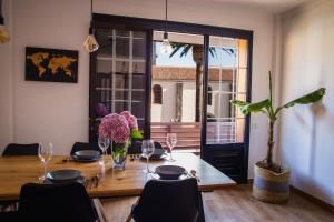 拉古納的住宿－La Laguna Treasure: exclusiveness prime location，用餐室配有带玻璃杯和鲜花的桌子