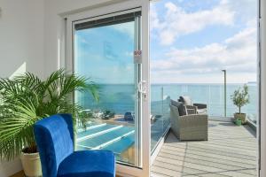 a room with a balcony with a view of the ocean at Channel View Boutique Hotel - Adults Only in Paignton