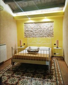a bedroom with a bed and two tables with lamps at Antichi Quartieri in Piazza Armerina