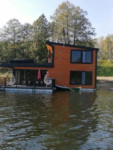a house on the water with a dock at Dom na wodzie in Piecki