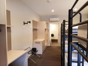 a dorm room with bunk beds and a staircase at Leumeah Lodge in Canberra