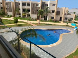 Bazén v ubytování Appartement de LUXE Marina SAIDIA avec vue sur PISCINE Résidence TAMARIS nebo v jeho okolí + 37 fotografií