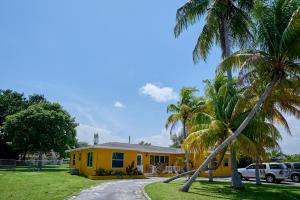 a yellow house with palm trees in front of it at Fabulous Hollywood Living Space in Hollywood