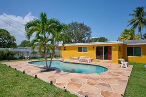 a yellow house with a swimming pool in the yard at Fabulous Hollywood Living Space in Hollywood