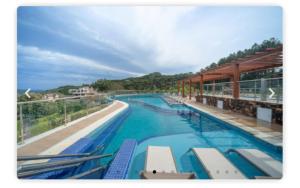 a large swimming pool with blue water at Golden Gramado Resort in Gramado