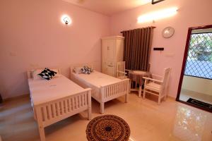 Postel nebo postele na pokoji v ubytování Nirrvaan homestay