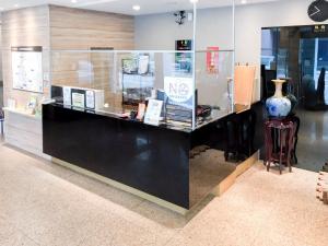 a display case in a store with a vase on it at Fudi Hotel in Taichung +16 photos