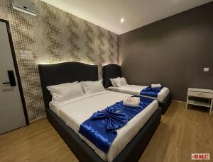 Postel nebo postele na pokoji v ubytování BMC Hotel