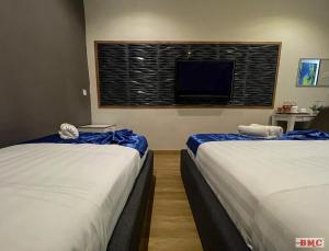 Postel nebo postele na pokoji v ubytování BMC Hotel