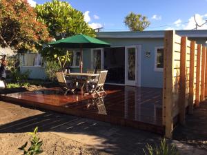 a wooden deck with a table and an umbrella at Blue in Pohara