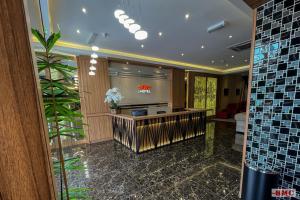 a lobby with a reception desk in a building at BMC Hotel in Ipoh