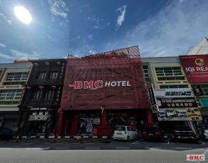 a building with a bmc hotel on a city street at BMC Hotel in Ipoh