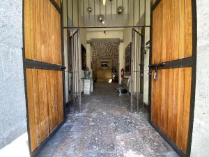 a hallway with wooden doors in a building at Hotel Escala Puebla Centro in Puebla