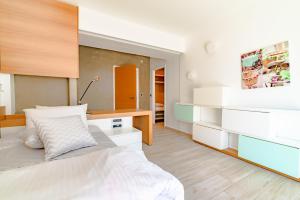 a bedroom with a bed with white drawers and a desk at Candia Boulevard in Heraklio Town +45 photos