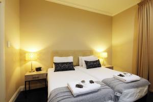 a hotel room with a bed with towels on it at Whyalla Playford Apartments in Whyalla