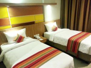 Voodi või voodid majutusasutuse Kyriad Hotel Airport Jakarta toas
