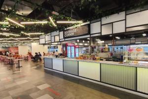 a large food court with a counter in a store at Kozi Square New SGH Cozy Home LV5B in Kuching